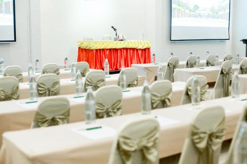a conference room with tables and chairs and a podium at Summer Tree Hotel in Bangna