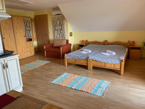 sypialnia z łóżkiem i krzesłem w obiekcie HolidaySport Haus w mieście Balatongyörök