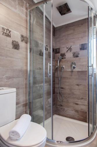 a bathroom with a shower with a toilet at Ziv Boutique Apartments Town Square in Lefkada Town