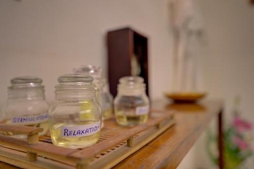 a shelf with four glass jars on a table at The Promenade in Puducherry
