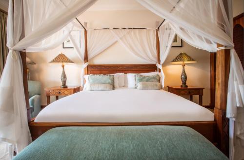 A bed or beds in a room at Avani Pemba Beach Hotel