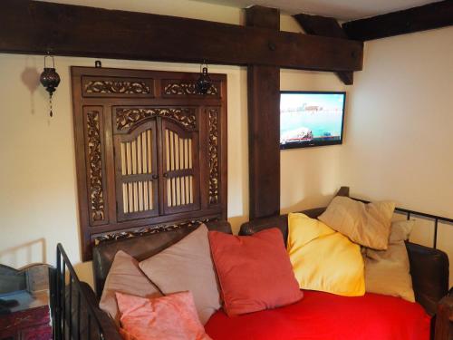 a living room with a couch with colorful pillows at Les Remparts in Binche