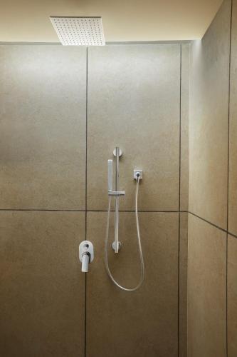 a shower in a bathroom with a glass door at The Residency Towers Puducherry in Puducherry