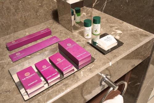 a bathroom counter with pink products on it at The Residency Towers Puducherry in Puducherry