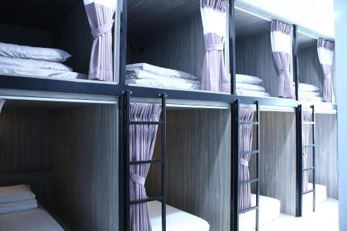 a group of bunk beds in a room at Freezone Hostel in Xiaoliuqiu