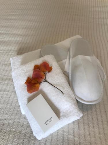 a white napkin with a flower on top of it at Ammos Luxury Studios in Aliki