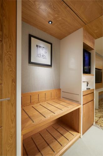 a closet with wooden shelves and a picture on the wall at The Residency Towers Puducherry in Puducherry