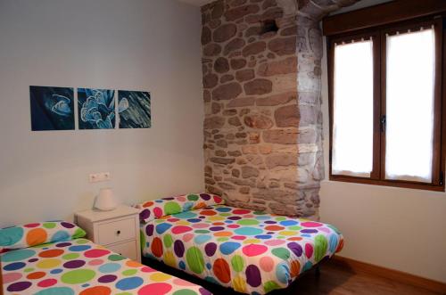 Katil atau katil-katil dalam bilik di Apartamentos Elizondo