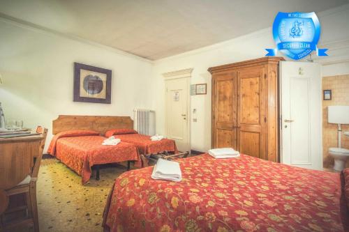 a hotel room with two beds and a dresser at B&b Allegri in Venice