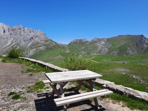 a wooden picnic table sitting on top of a mountain at Hosteria Picos De Europa in Potes