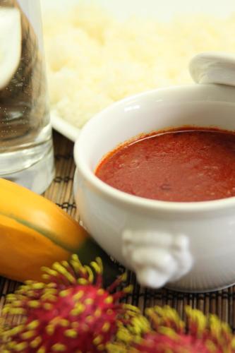 a bowl of sauce next to a bunch of fruit at HOTEL BANJAR in Tokorozawa