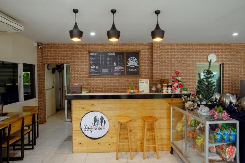 a bar in a restaurant with a brick wall at Ioon Resort ไออุ่นรีสอร์ท in Sara Buri