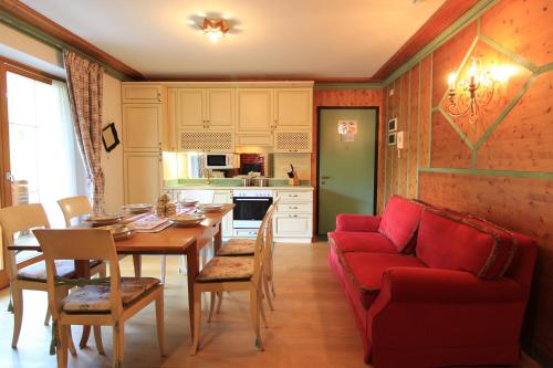 sala de estar con sofá rojo y mesa en NOCKFLAIR Apartment by Isa Agentur, en Bad Kleinkirchheim