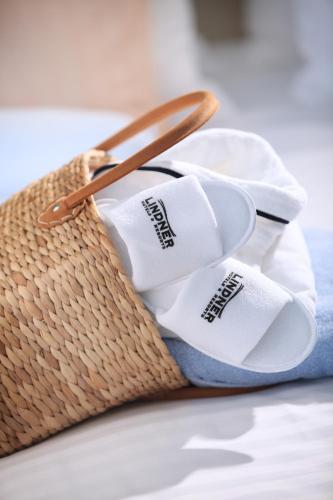 a basket with rolled up towels and a spoon at Lindner Hotel Cologne Am Dom, part of JdV by Hyatt in Cologne