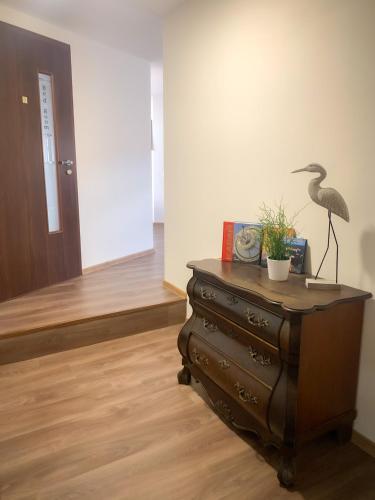 a room with a dresser with a bird on top of it at JP-KU ubytování Kadaň in Kadaň