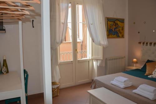 a bedroom with a bed and a large window at Guest house Le Sibille in Taormina