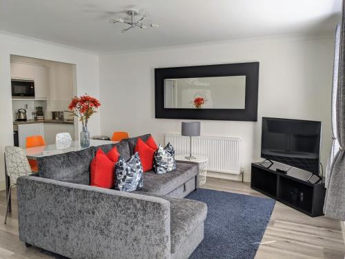 a living room with a couch and a television at Saffron Court by Wycombe Apartments - Apt 06 in High Wycombe