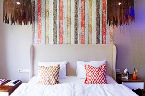 a bedroom with a white bed with two pillows at Hotel Piwniczna SPA&Conference in Piwniczna