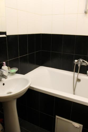 a bathroom with a sink and a bath tub at Квартира-студия in Chernihiv