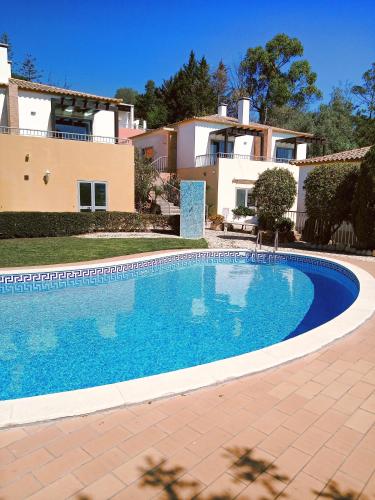 a swimming pool in front of a house at Quinta dos Caracois in Lagos