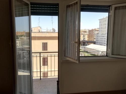 an open window with a view of a city at Porta Maggiore GH Locazione Turistica in Rome