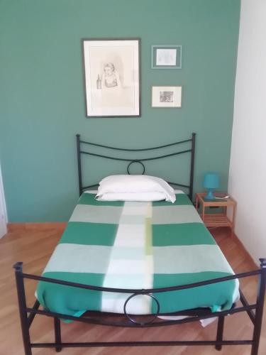 a bed in a room with a blue wall at Porta Maggiore GH Locazione Turistica in Rome