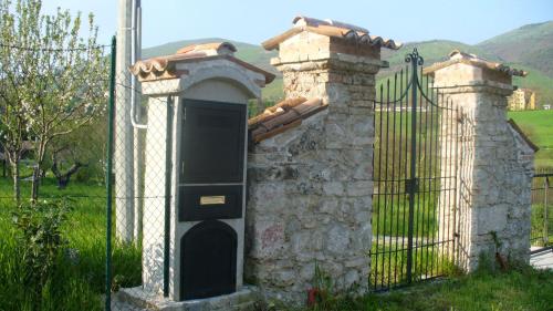 a gate with a black door next to a fence at Tenuta de Maffutiis in Polla