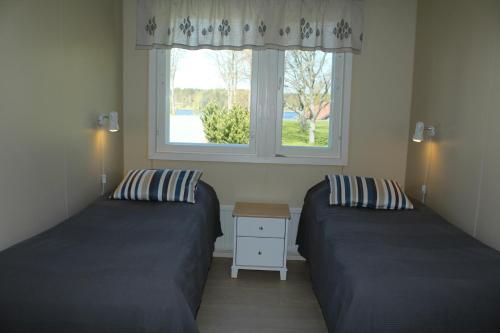 Ένα ή περισσότερα κρεβάτια σε δωμάτιο στο Labbnäs Semesterhem, Radhuset