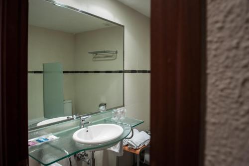 a bathroom with a sink and a mirror at Hotel Unzaga Plaza in Éibar