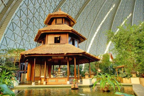 a large building with a pond in front of a building at Tropical Islands in Krausnick