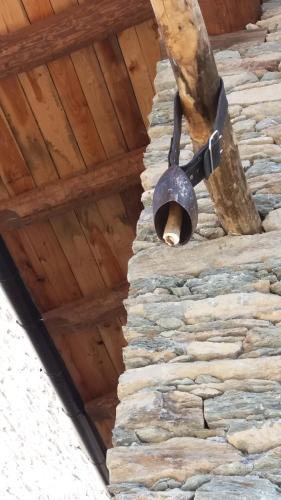 a light on a stone wall under a wooden ceiling at Rifugio Alpino Baudinet - Trek&Relax in Chiusa di Pesio