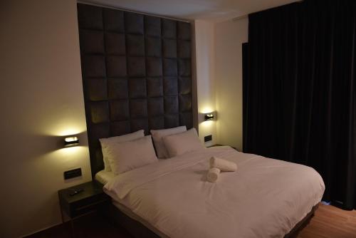 a bed with a stuffed animal sitting on top of it at Selfie's Boutique Hotel in Tiberias