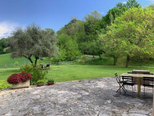 a patio with a table and chairs in a park at Armonia della Sera B&B and Relax in Porto SantʼElpidio