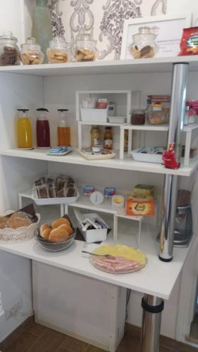 a white shelf filled with lots of food at Il Roseto in Frosinone