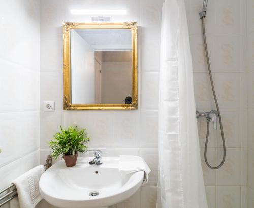a white bathroom with a sink and a mirror at La Llevantina Boutique Villa in Calonge