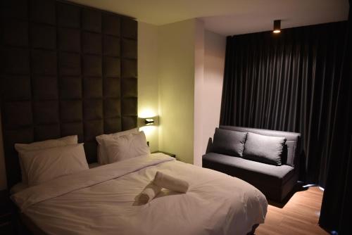 a hotel room with a bed and a chair at Selfie's Boutique Hotel in Tiberias