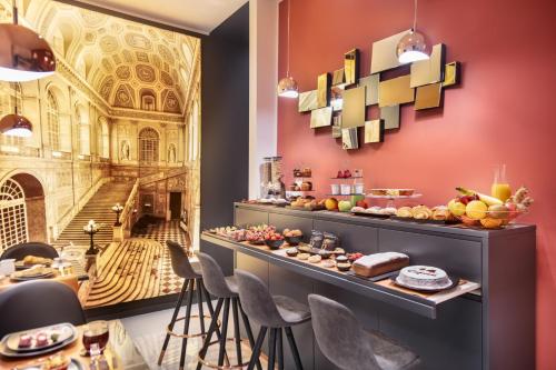 a breakfast buffet in a restaurant with a mural of a building at La Lepre Napoli in Naples