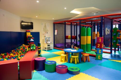 a childrens play room with a play floor and a play equipment at Hotel Putnik Kopaonik in Kopaonik