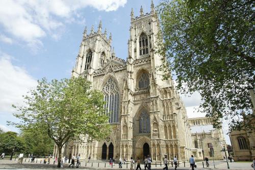a large cathedral with people walking in front of it at Novotel York Centre in York