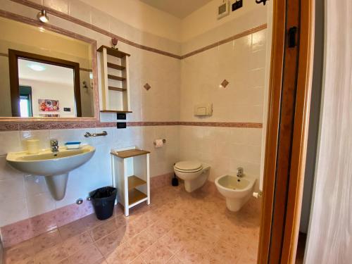 a bathroom with a sink and a toilet and a mirror at Residence Bellavista in Manerba del Garda