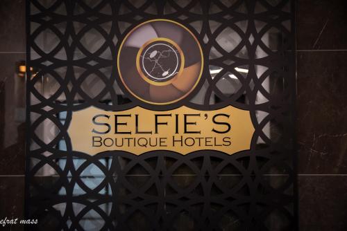 a sign for a hotel on a gate at Selfie's Boutique Hotel in Tiberias