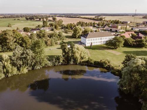 an aerial view of a building next to a lake at Gutshaus Groß Helle in Mölln