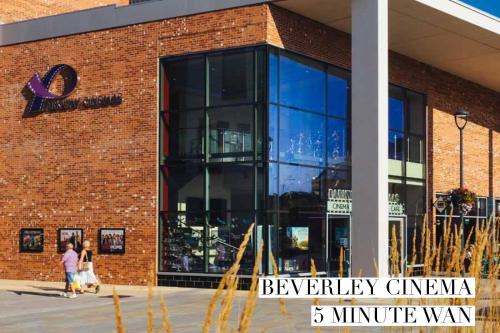 a brick building with people walking in front of it at 52 Minster in Beverley