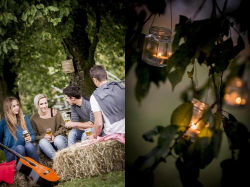 a group of people sitting on a hay bale at Berry House in Vigolo Vattaro