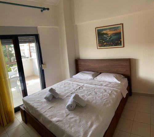 a bedroom with a bed with towels on it at Stella Maisonette Hanioti in Hanioti