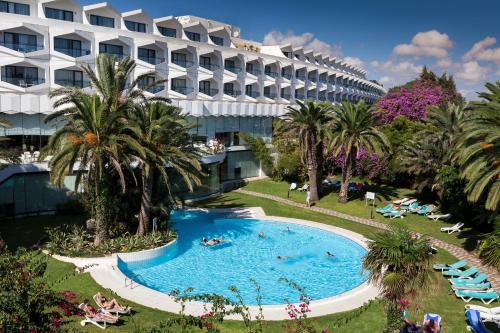 a resort with a large swimming pool next to a building at Sentido Phenicia in Hammamet