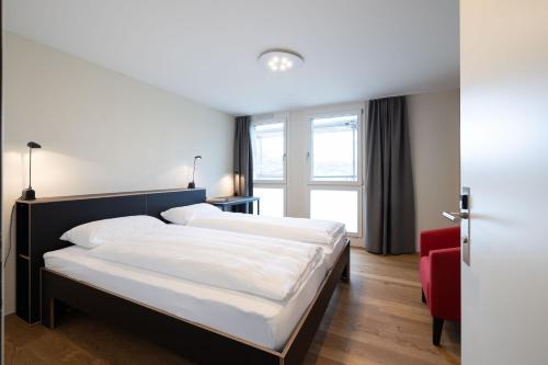 a hotel room with two beds and a window at B&B Hotel Mattli Übernachtung Frühstück in Morschach