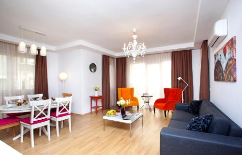a living room with a couch and a dining room at The Room Hotel & Apartments in Antalya