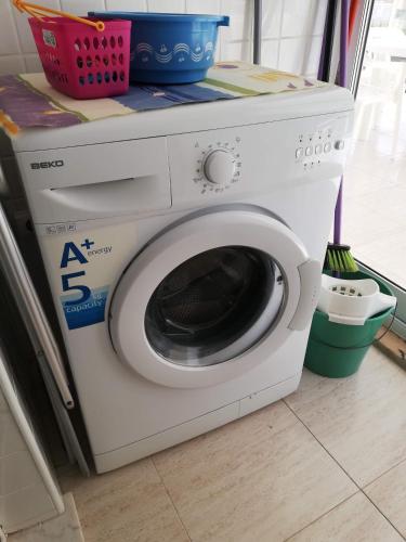 a washing machine sitting on top of a washer at Parquemar VIII Solo Familias Serviplaya in Xeraco