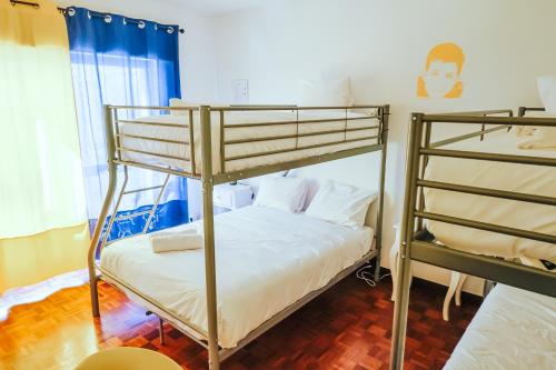 a bedroom with two bunk beds in a room at Help Yourself Hostels - Restelo in Lisbon